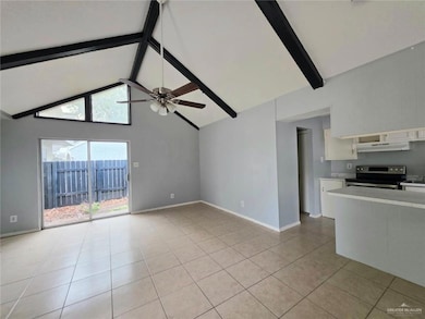Unfurnished living room featuring ceiling fan, beam ceiling, light tile patterned floors, and high vaulted ceiling
