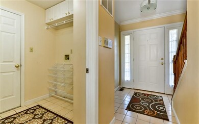 Light and bright ceramic tiled entry and mudroom