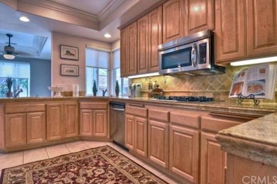 Kitchen with travertine tile counters.