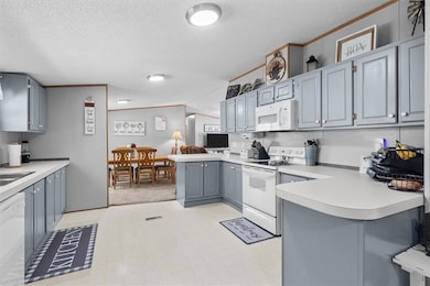 Kitchen with ornamental molding, a peninsula, whit