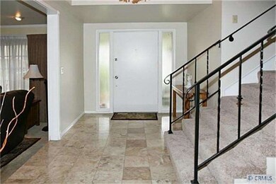 Huge foyer with beautiful travertine flooring. Sta