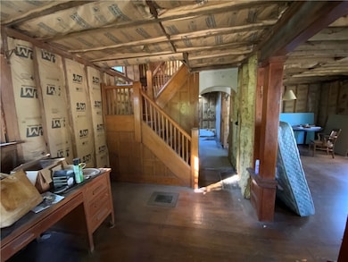 generously sized formal entry with original wainscoting on stairs