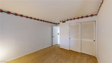 Unfurnished bedroom featuring carpet floors and a closet