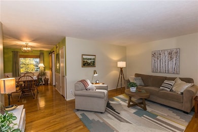 Living area featuring wood finished floors and a chandelier