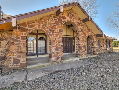 Entrance to property featuring stone siding
