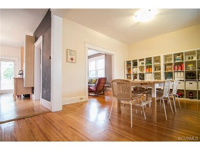 The dining room is spacious and bright, refinished original hardwood floors.