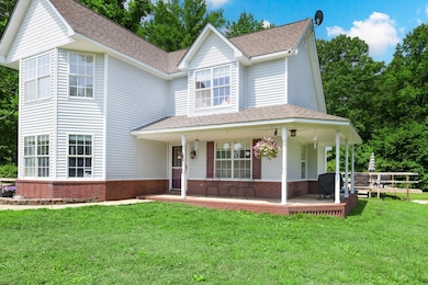 Victorian house featuring brick siding, a shingled roof, a front lawn, and covered porch