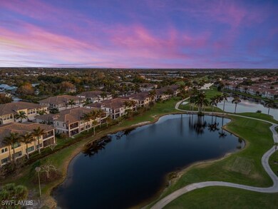 Aerial view at dusk featuring a water and golf cou