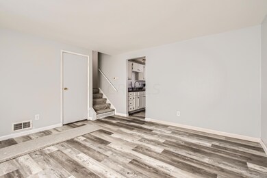 Another view of living room into kitchen