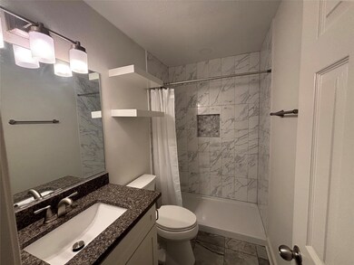 Full bath with a shower stall, toilet, vanity, an