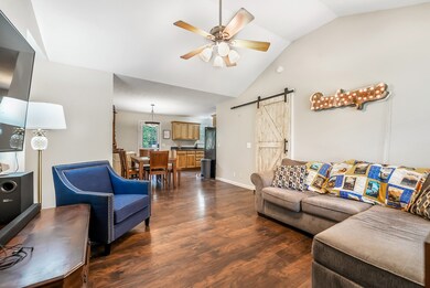 Cozy living room leads into dining area.