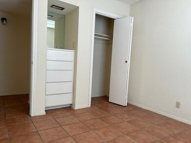 Unfurnished bedroom with light tile patterned flo