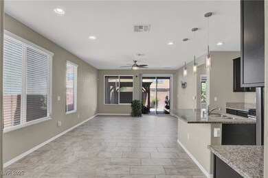 Kitchen featuring a sink, a ceiling fan, light sto