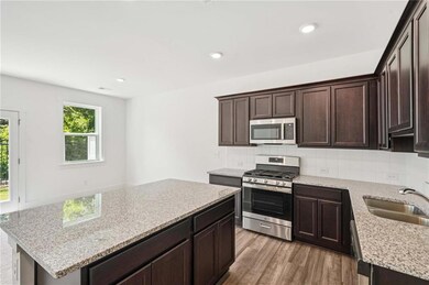 Granite and Stainless Appliances with Stained Cabinets