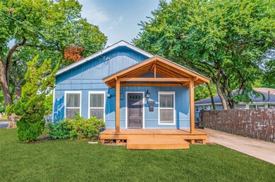 Back of house with a lawn and a wooden deck