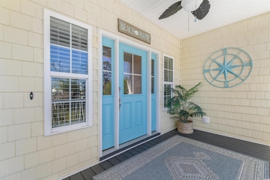 Entrance to property featuring a ceiling fan