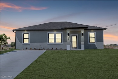 View of front of house with a shingled roof, stucc