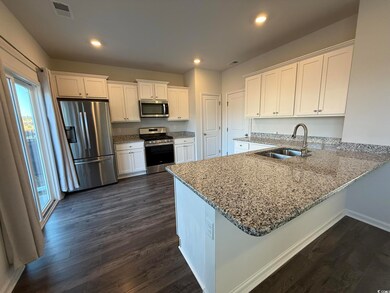 Kitchen with kitchen peninsula, appliances with st