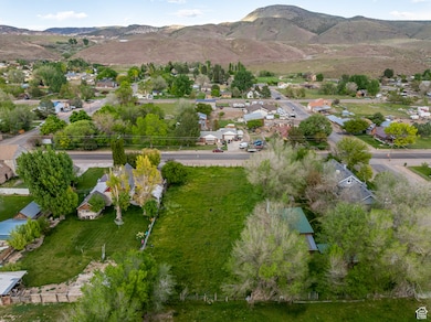 Aerial overview of property's location featuring nearby suburban area and mountains