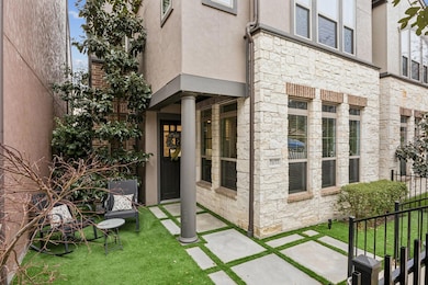 Property entrance featuring stone siding, a yard, 