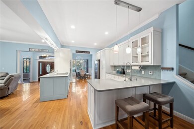 The kitchen is a chef's haven, beautifully updated with modern aesthetics and functional features.