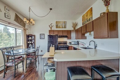 Kitchen featuring black appliances, a peninsula, l