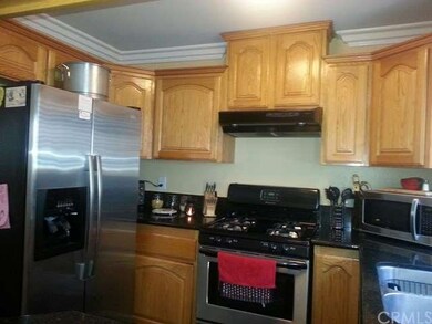 Kitchen with granite countertops, windo by the sin