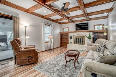 Cozy masonry fireplace framed by built-ins with de