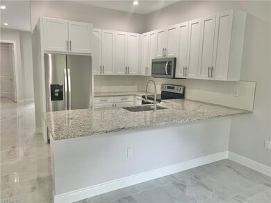 Open kitchen with breakfast bar.