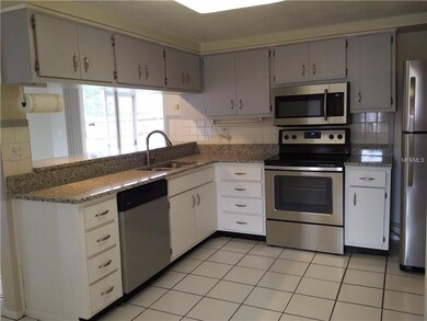 Kitchen with new granite counter top, bar top, and