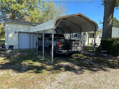 Carport in front of 2 car garage