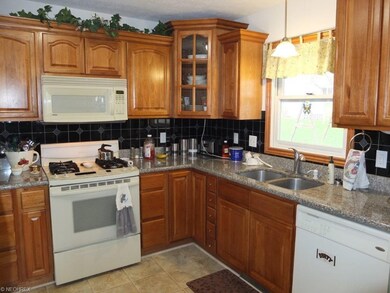 Fully applianced kitchen has granite countertops a