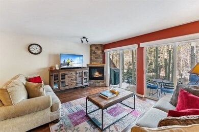 Living area featuring a gas fireplace and wood flo