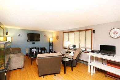 Large living room with bay window and hardwood flo