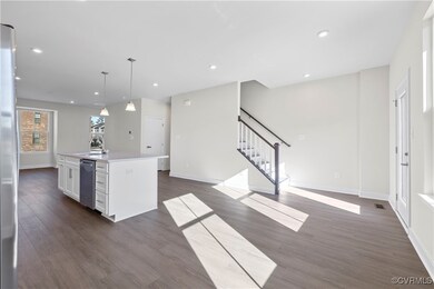 Kitchen with dark wood-style flooring, baseboards,