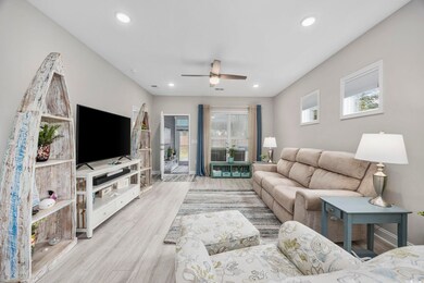 Living room with light hardwood / wood-style floors and ceiling fan