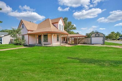 View of front of property with a garage, a front y