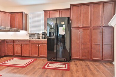 Kitchen with decorative backsplash, light stone co