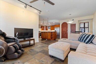 Living room featuring stone tile flooring, a ceil