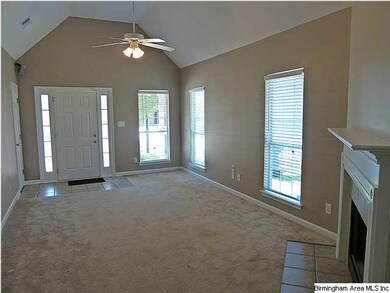 Great room with vaulted ceiling and wood burning f