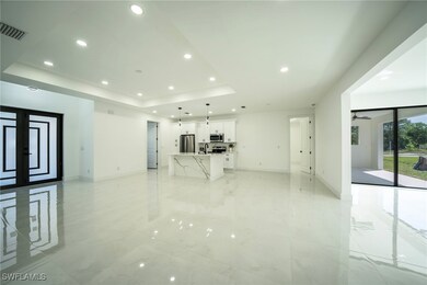 Unfurnished living room with recessed lighting, ba