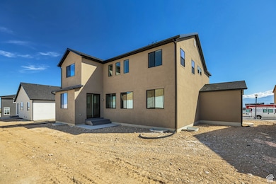 Rear view of property featuring stucco siding