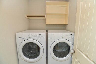 Laundry / utility room with built-in shelf.