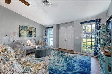 Living room featuring ceiling fan, vaulted ceiling