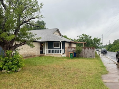 View of front of home with a front yard, a porch,