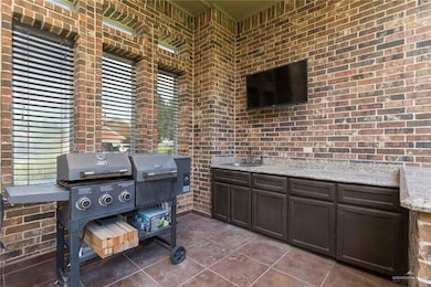 Covered patio, outdoor kitchen with a sink & TV
