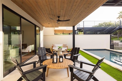 View of patio featuring ceiling fan, an outdoor pool, and outdoor dining area
