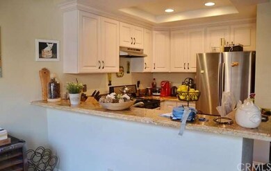 Remodeled kitchen with solid wood cabinetry, grani