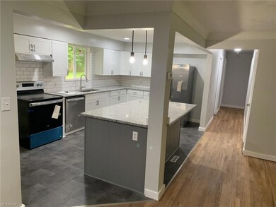 Kitchen featuring backsplash, light countertops, w