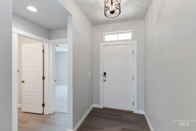 Foyer entrance featuring dark wood-style flooring and recessed lighting